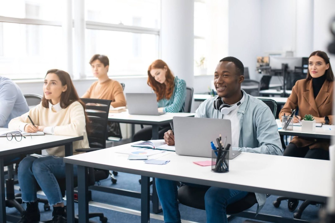 Students in a classroom sitting with laptops