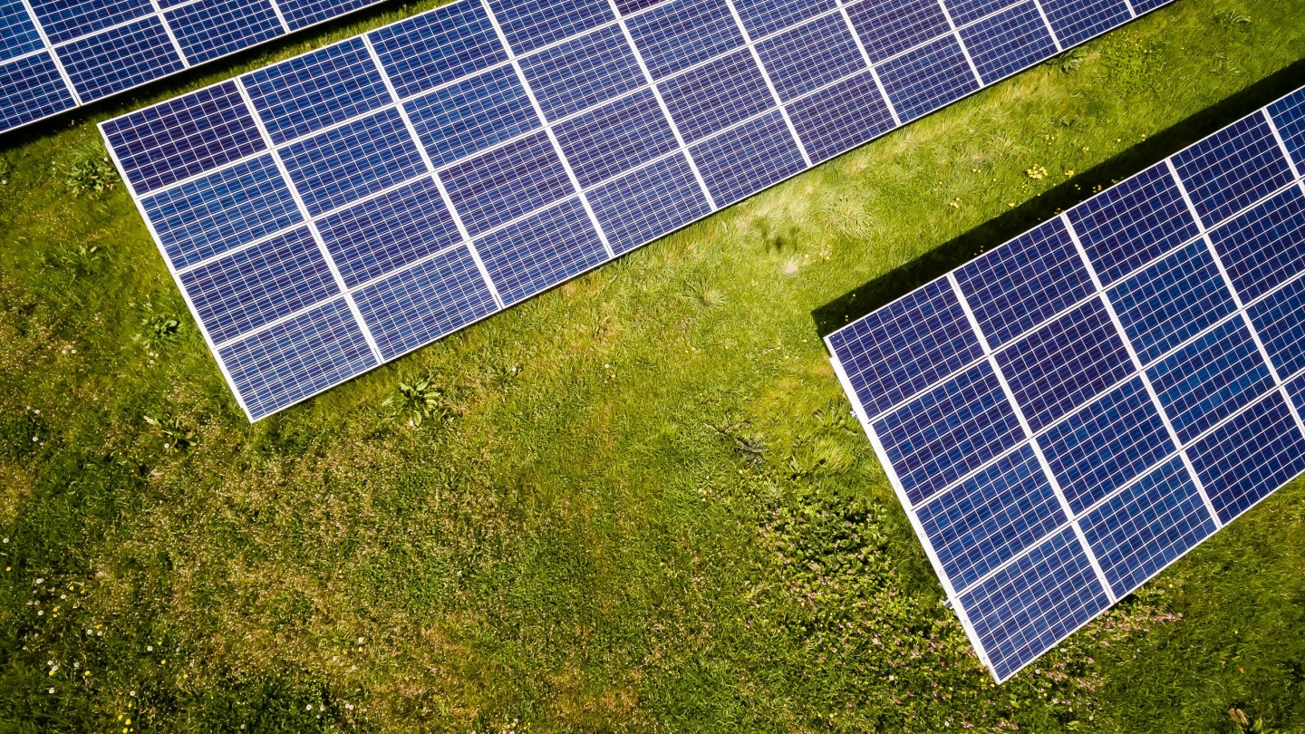 Solar panels sitting on top of grass